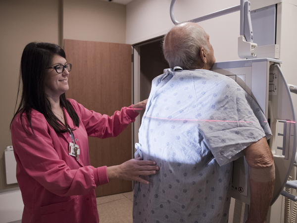 Kim Gladney, a radiological technologist, performs a scan on patient Henry Wood.