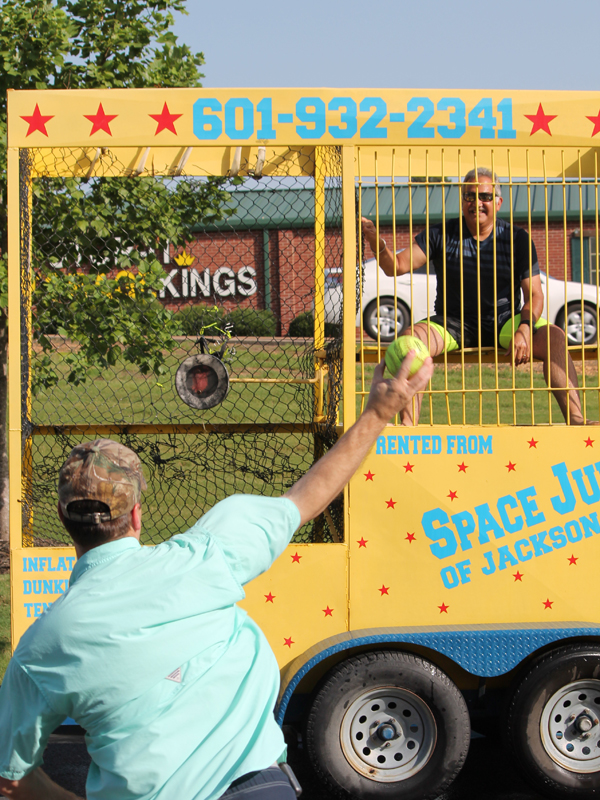 UMMC Grants Ferry's Dr. Charles Ouzts takes a shot at dunking Dr. Ray Rodriguez. (Photo courtesy Rod Simmons, an LPN at Grants Ferry.)