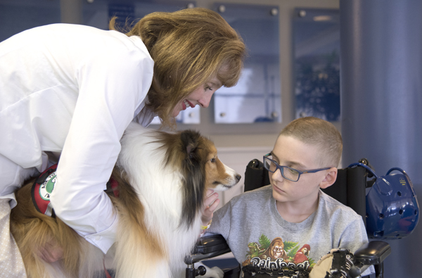 Caldwell "Call" Wilson, 11, right, a Batson Children's Hospital patient, is greeted by Susan Raphael and Lyla. His mom, Marcy Wilson, brought him to Batson from their home in Monterey, La. It was Call's first time to meet Lyla.