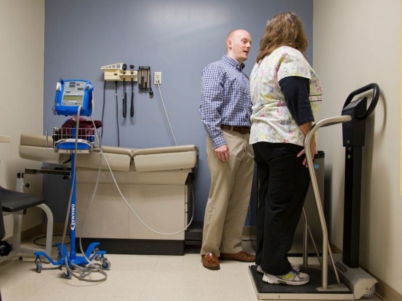 UMMC registered dietitian Paul Robertson takes the weight and height measurements of patient Edna Taylor of Bentonia.