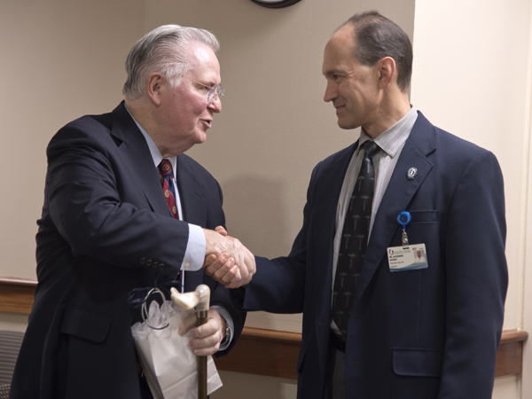 Dr. James Corbett, left, is congratulated and thanked for his 25 years of service to the Medical Center by Dr. Alexander Auchus during a retirement reception Thursday in the B.B. Richardson Hospital Administration Conference Room.