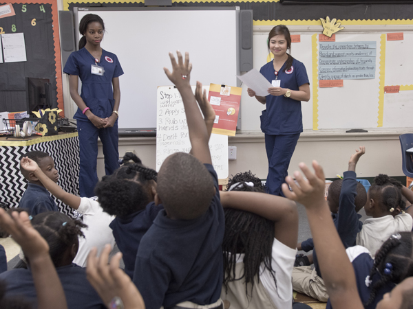 Nursing students Meagan Coleman, left, and Shairah Hortelano quiz students at French Elementary in Jackson on hand hygiene knowledge.