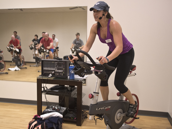 Emily Tullos, a group fitness instructor at the University Wellness Center downtown Jackson branch, leads a spin class.