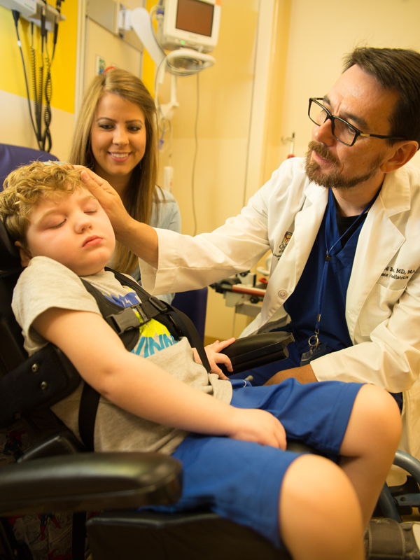 Boyte examines patient Cooper Newell as his mother Noel looks on. Photo credit: The Schwartz Center for Compassionate Healthcare