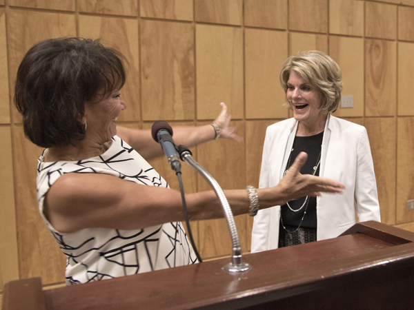 Sara Ray, left, welcomes Suzan Thames with a hug.