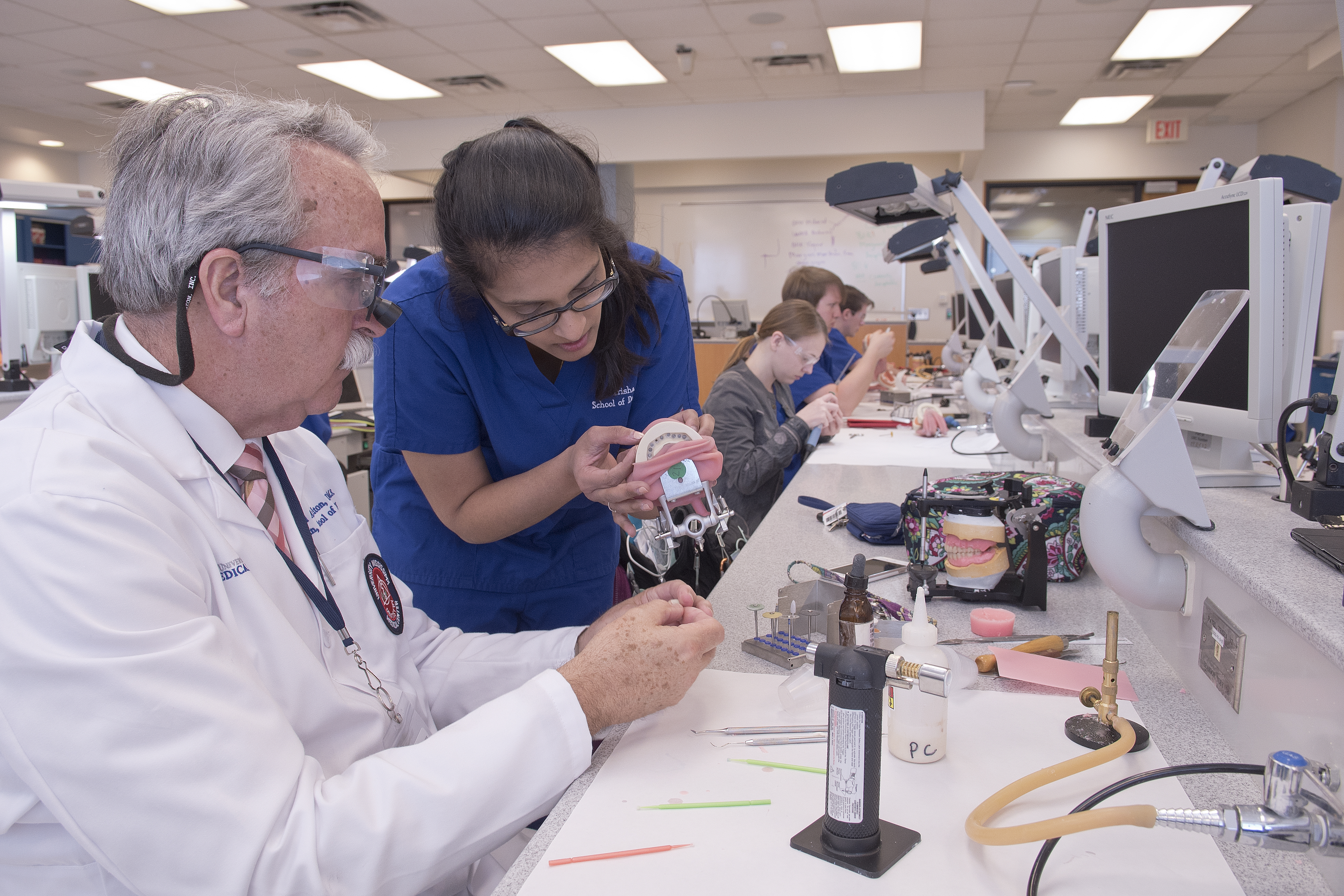 Felton assists D2 Trisha Patel with making a provisional for a fixed partial dental prosthesis.