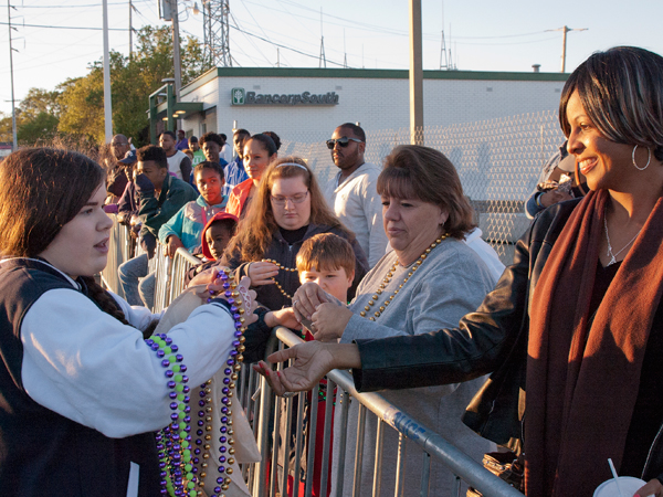 Children's Miracle Network Champion for Mississippi Hannah Dunaway hands out Mardi Gras beads and takes donations at the parade.