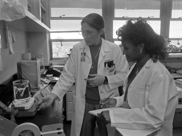 Jerlen Young, right, a member of one of the early Base Pair classes in 1992-1993, works with her mentor and longtime Base Pair leader, Dr. Donna Sullivan.