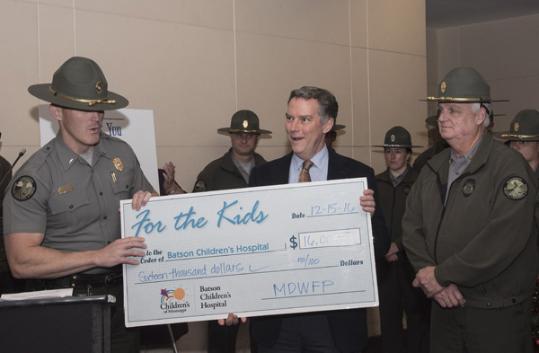 Lt. Chris Reed of the Mississippi Department of Wildlife, Fisheries and Parks presented Dr. Rick Barr, Suzan B. Thames Professor and chair of pediatrics, with a check for $16,000. The money raised during fundraisers throughout the year will go to child life at the state's only children's hospital.
