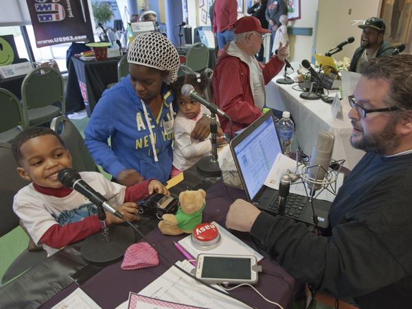 DeNarahri Middleton, left, makes his radio debut during the 2015 Radiothon with Vicksburg station K-Hits while mom Decimbra and sister Deniylah listen in.