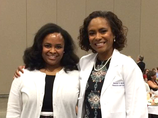 Kandice Bailey, left, attends the long coat ceremony for her sister Dr. Summer Bailey.