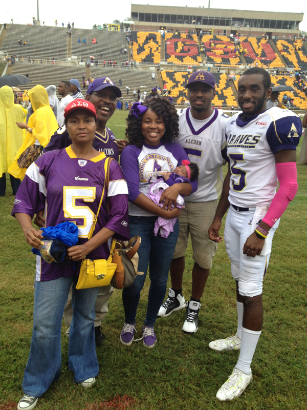Nate Hughes, second from right, and other members of his family visit Nate's brother Charles Hughes, far right, at an Alcorn State University football game. The others are, from left: mom Gwendolyn Hughes, dad Nathaniel N. Hughes, and sister Morgandy Hughes, holding Nate Hughes' daughter Zhoë, who turns 2 this year.