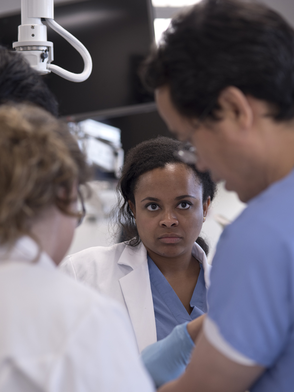 Bailey focuses on instructions from Dr. Yuefeng Lu, right, during her second day in the Gross Anatomy lab.