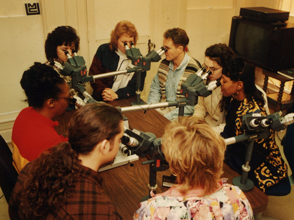 Cason, left in red, views slides with a class of cytotechnology students in the '80s.