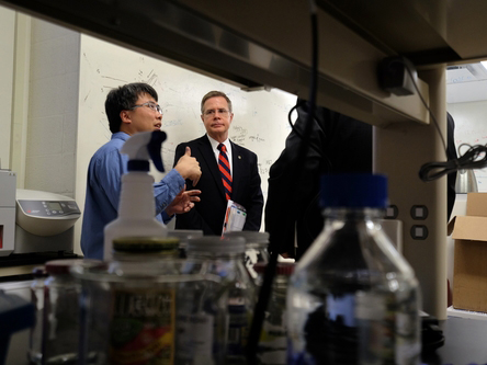 Dr. Erik Hom (left), assistant professor of biology at UM, explains his research on microbial communities to Vitter during a visit to Hom's lab as part of Vitter's Flagship Forum tour.
