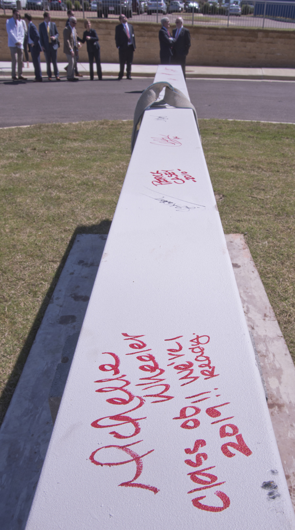 The signature of first-year medical student Michelle Wheeler is among those inscribed on the construction beam before it is hoisted to the top of the new School of Medicine site.