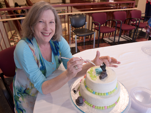 Mary McNair, assistant professor of nursing, prepares to dig in Thursday after defending her dissertation.