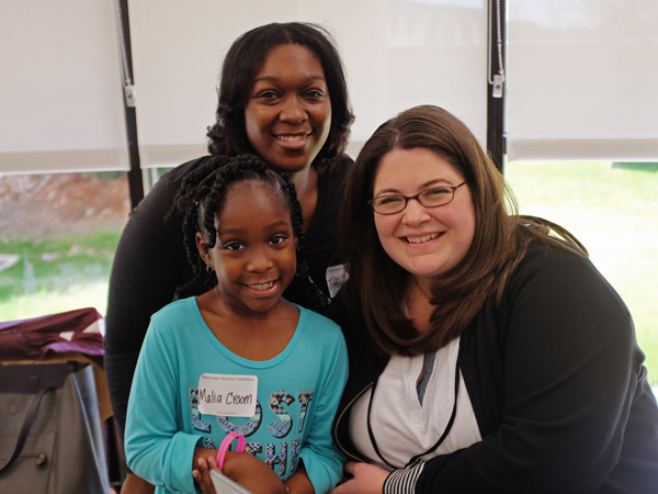 Tiffine Croom and daughter Malia Croom, a former Batson Children's Hospital patient, smile with Shannon Steele of Mix 98.7 March 2 during the March 2016 Mississippi Miracles Radiothon.