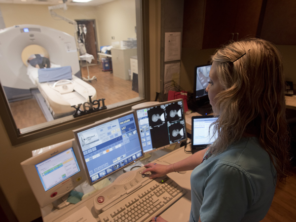 Registered nuclear medicine technologist Mary Beth Croisdale begins the PET scan of Hankins.