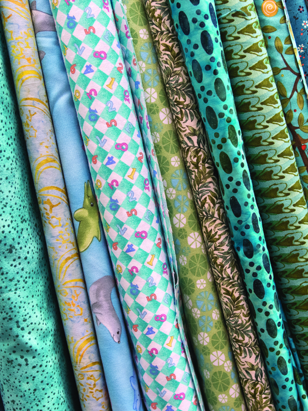 Bolts of fabric in the Susannah Stitchers’ storage room sit waiting to be cut and sewn into place.