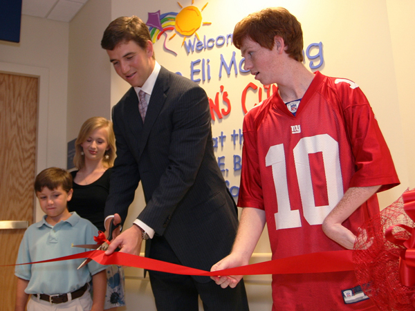 In 2009, Eli cuts the ribbon for the Eli Manning Children's Clinics with help from Batson Children's Hospital patients, from left, Cameron Smyly, Aubree Jordan and Taylor Gibson.