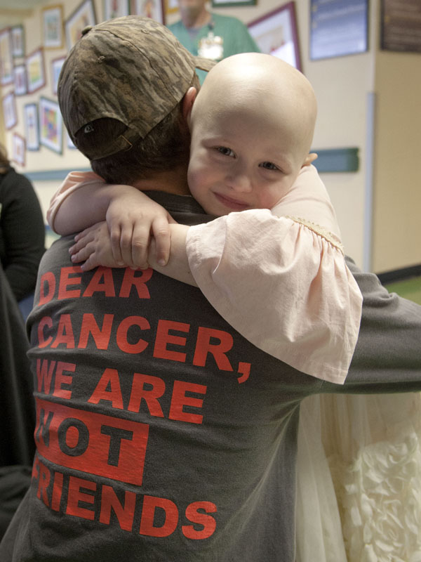 Magnolia Jones gets a hug from her brother, Grayson DeVito, in the lobby of Batson Children's Hospital during Radiothon 2015.