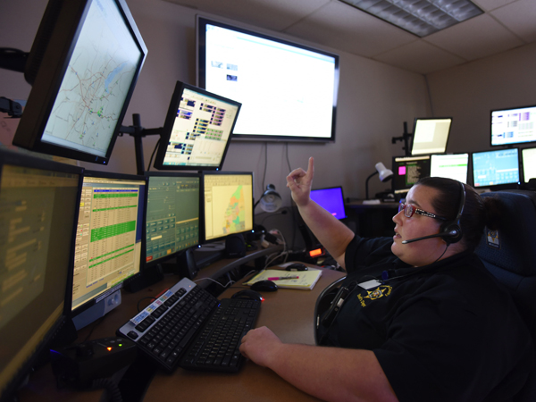 Melissa Swope, a shift sergeant at the Rankin County Sheriff's Department, prepares to answer 911 calls as she communicates with first responders.