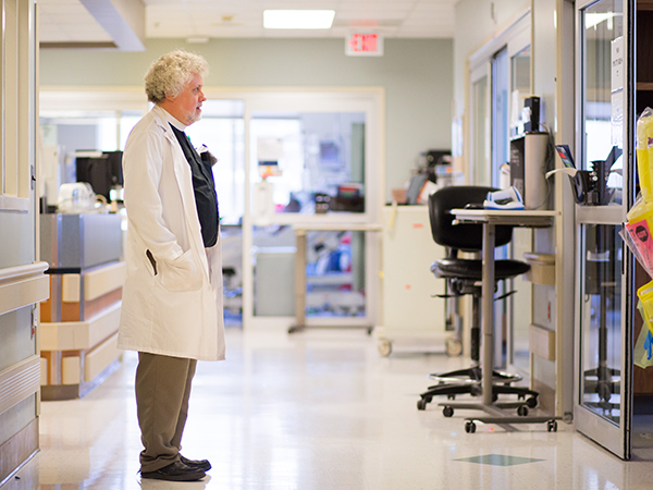 Murphy pauses before entering a patient's room while making daily rounds through the Neuroscience ICU.