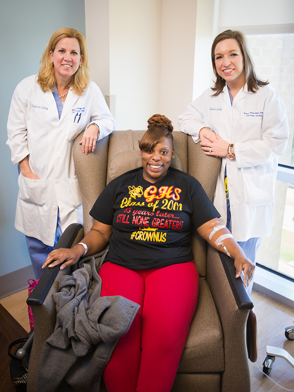 Harps relaxes with Dr. Mildred Ridgway, left, and Bethany Sabins.