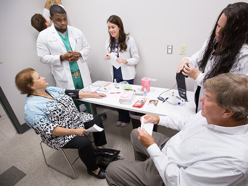 Belzoni residents Wilma Thomas, seated left, and Bill Allen, seated right, take advantage of a free health screening at the new Community Care Clinic.