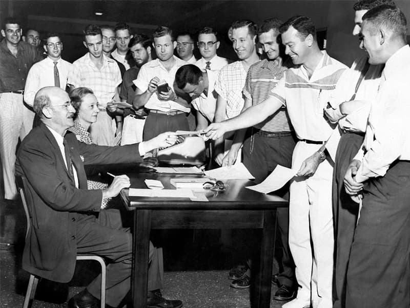 The first dean of the Jackson-based School of Medicine, Dr. David Pankratz, seated, registers an early class of medical students.