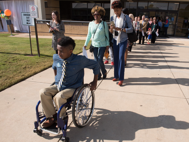 Batson Children's Hospital patient K.J. Fields leads a procession of patients and family members at the groundbreaking.