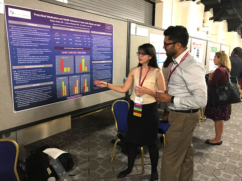 At the 2017 AACAP Annual Meeting, Salter describes her findings to Dr. Raymond Chankalal, a fellow at the University of Buffalo's Department of Psychiatry.