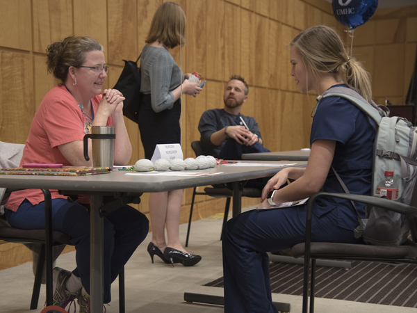 Ramie Polk, nurse manager on 4-south, discusses open positions in the stroke program with Morgan Maloney.