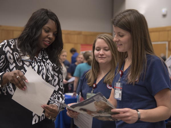 Farrah Banks talks with seniors Megan Christy and Megan Bauerle.