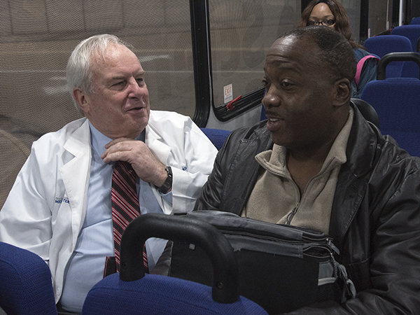 Henderson chats with IT support analyst Walter Allen on a UMMC shuttle bus.