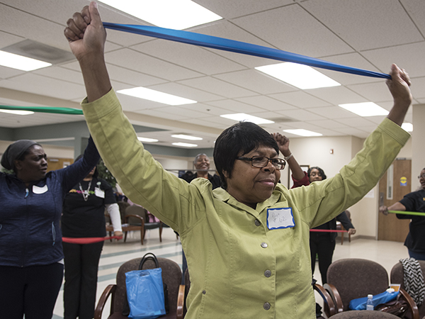 Annie Davis participates in the exercise demonstration led by UMMC occupational therapists Summer Brewer and Diane Satterfield.