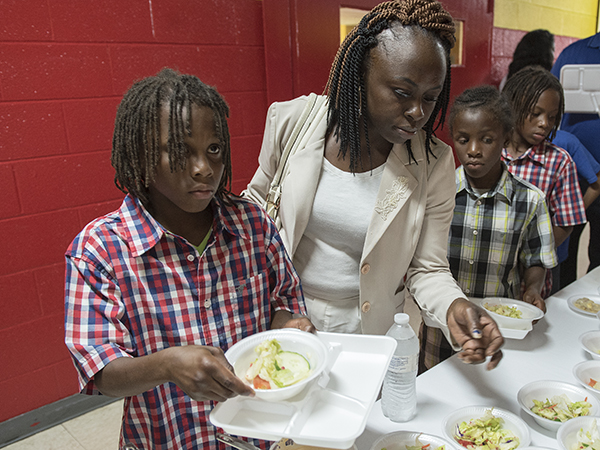 Jonestown mom of five Otibehia Allen, 32, and three of her five children -- twins Javarious, left, and Jamarious Gilliam, right, and son George Gilliam -- choose salads during a lunch at Madison Shannon Palmer High in Marks.