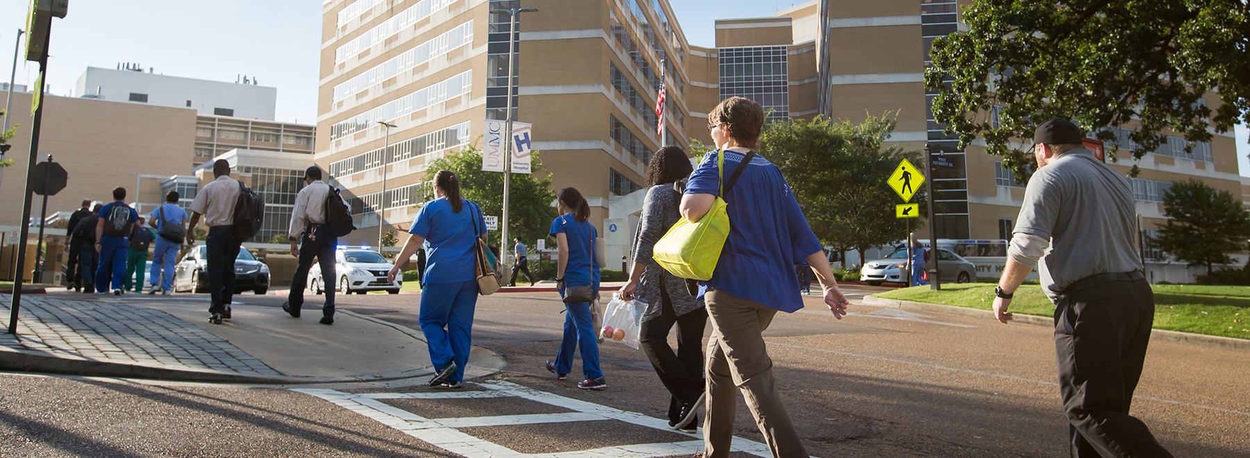 UMMC employees using crosswalk in front of University Hospital..