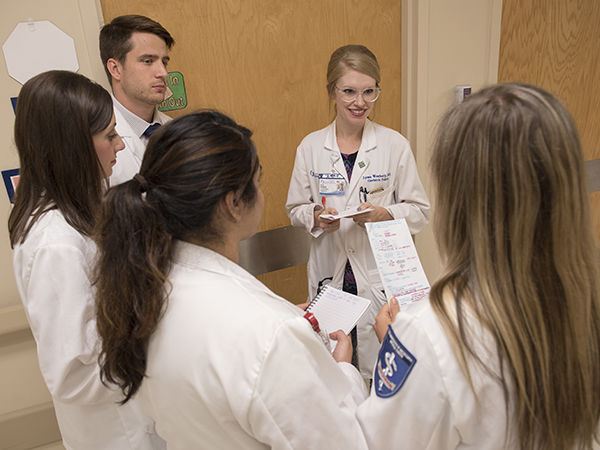 Lyssa Weatherly, center, assistant professor of medicine, with third year medical medical students.