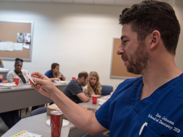 Eric Johnson oversees a round of Spanish Bingo during a meeting of the Hispanic Student Dental Association.