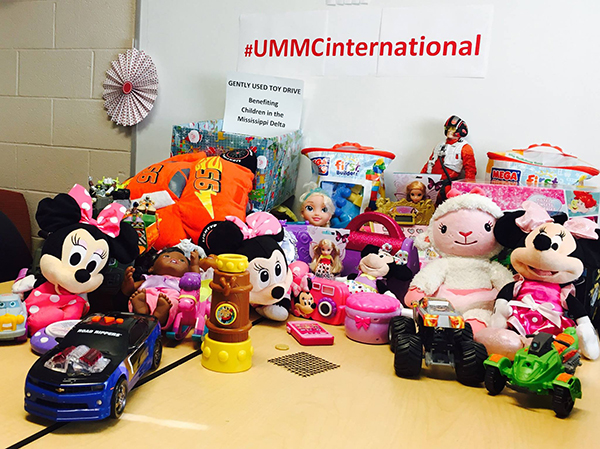 Irene Arguello and members of the international community collect toys for children being treated at the SON's Rolling Fork and Mayersville clinics.