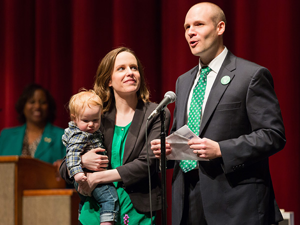 Brock Banks announces his match in family medicine at Forrest General Hospital in Hattiesburg while his wife, Mary, and their child look on.