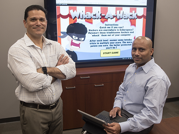 Adrian Castillo, left, a DIS interactive digital developer, and senior web software developer Venu Peddireddy created Whack-A-Hack,