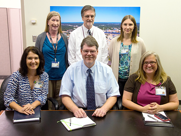 Public Affairs’ staff writers and their respective primary areas of responsibility include, front row from left, Annie Oeth, pediatrics; Bruce Coleman, Medical Center operations and administration; and Alana Bowman, Schools of Dentistry, Nursing and Health Related Professions; and back row from left, Ruth Cummins, clinical operations, emergency services and telehealth; Gary Pettus, School of Medicine; and Karen Bascom, research and School of Graduate Studies in the Health Sciences.