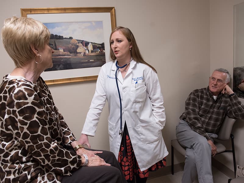 As her husband Lee listens, Canton resident Judith Bramlett discusses her latest cancer treatment with Wilkinson.