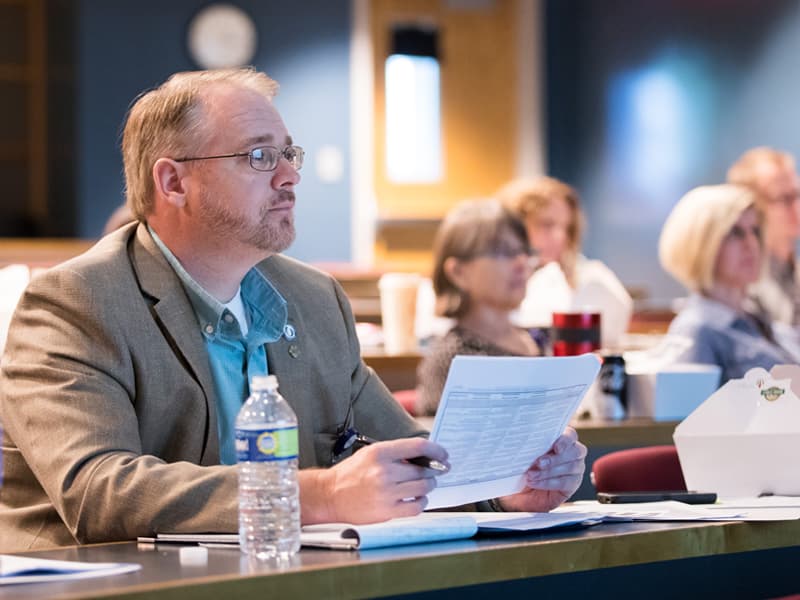 Dr. Mark Gray, left, associate professor of radiologic sciences and associate dean for academic affairs, and other School of Health Related Professions faculty attend the SHRP P&T Educational Forum Sept. 22.