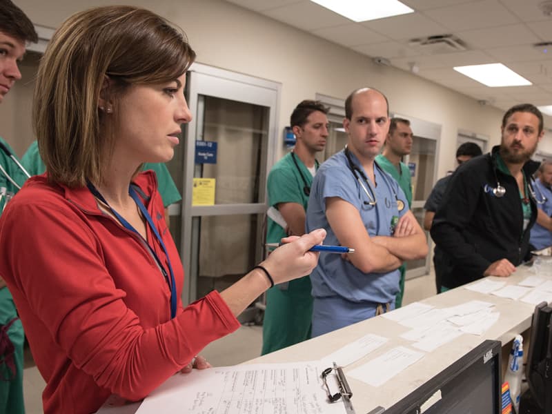Rebecca Benson, a nurse manager in the Adult ED, gives instruction on patient care to nurses and residents as part of a mass casualty drill.