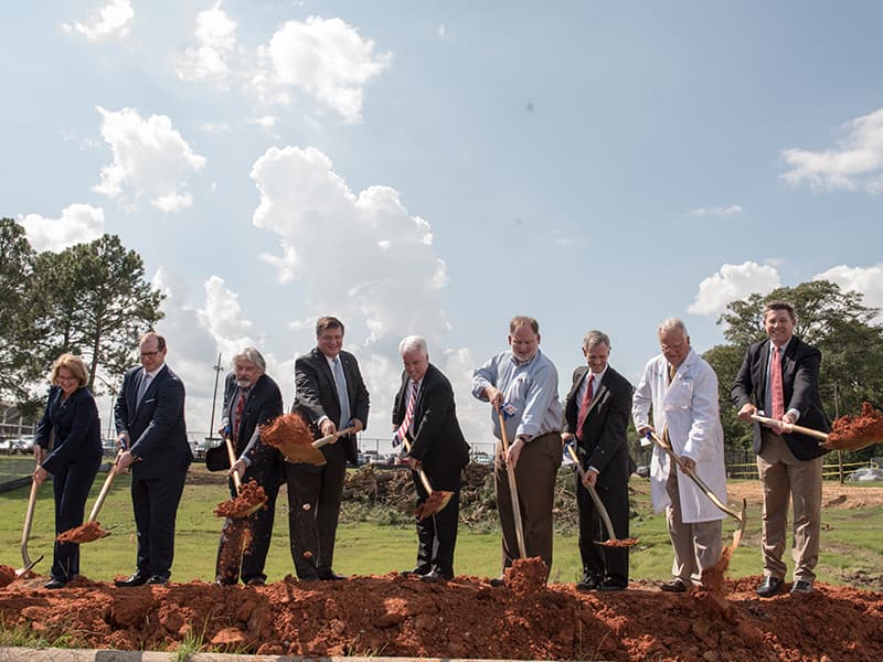 The shovels make it official. The first throw of the dirt was taken by those who have worked to build the American Cancer Society Ford Hope Lodge and representatives of hospitals whose patients will use it. From left are, Sheila Grogan, Blue Cross/Blue Shield of Mississippi; Kirk Sims, Yates Construction; Dr. Ralph Vance, professor emeritus, UMMC, and ACS Capital Campaign Committee member; Jerry Host, president and CEO of Trustmark Corporation and Capital Campaign Committee chair; Mike Neal, ACS executive vice president; John Lewis, Gertrude C. Ford Foundation director; Claude Harbarger, president of St. Dominic Health Services; Dr. John Ruckdeschel, UMMC Cancer Institute director; Whit Hughes, Baptist Health Services Foundation.