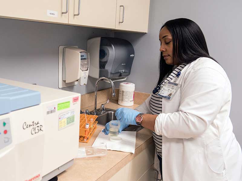 Clinical research nurse Shanita Greer prepares vaginal and urine specimens for transport, processing and storage at Express Personal Health in the Jackson Medical Mall.